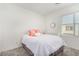 Bright bedroom featuring a comfortable bed, window with blinds, and a stylish decorative accent at 328 Owens Peak Dr, Henderson, NV 89015