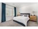 Bright bedroom featuring a plush bed, modern nightstands, and abundant natural light from a large window at 328 Owens Peak Dr, Henderson, NV 89015