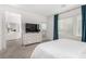 Bright bedroom featuring a dresser with mounted TV and view into ensuite bathroom at 328 Owens Peak Dr, Henderson, NV 89015