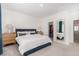 Spacious bedroom with a large bed, walk-in closet, and view into the ensuite bathroom at 328 Owens Peak Dr, Henderson, NV 89015