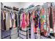 Walk-in closet featuring ample storage solutions including custom shelves, rods, and clear bins at 328 Owens Peak Dr, Henderson, NV 89015