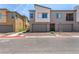 Modern townhome with a gray facade, landscaping and private garages at 328 Owens Peak Dr, Henderson, NV 89015
