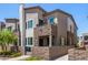 Attractive townhome featuring a stone facade, balcony, and a well-maintained front yard at 328 Owens Peak Dr, Henderson, NV 89015