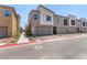 View of townhomes featuring private garages and well maintained landscaping at 328 Owens Peak Dr, Henderson, NV 89015