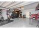 Well-organized garage with gym equipment, storage, epoxy floor, and overhead racks at 328 Owens Peak Dr, Henderson, NV 89015