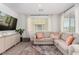 Bright living room featuring a comfortable sectional sofa, stylish rug, and modern decor at 328 Owens Peak Dr, Henderson, NV 89015