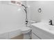 Bathroom with white shower-tub combo and white vanity sink with black hardware at 3793 Casa Colorado Ave, Las Vegas, NV 89121