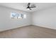 Bright bedroom with neutral walls, wood-look flooring, and a window with neighborhood views at 3793 Casa Colorado Ave, Las Vegas, NV 89121