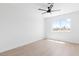 Bright bedroom featuring wood-look floors, ceiling fan, and a window with outdoor views at 3793 Casa Colorado Ave, Las Vegas, NV 89121