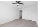 The neutral-toned bedroom has wood-look floors, a ceiling fan and closet and door to hall at 3793 Casa Colorado Ave, Las Vegas, NV 89121