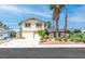 Charming two-story home featuring desert landscaping, a two-car garage and a mix of palm trees at 3793 Casa Colorado Ave, Las Vegas, NV 89121