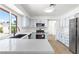 Bright and open kitchen features a breakfast bar, stainless steel appliances, and scenic backyard views at 3793 Casa Colorado Ave, Las Vegas, NV 89121