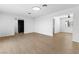 Open-concept living area featuring neutral walls and hardwood flooring, with access to additional rooms at 3793 Casa Colorado Ave, Las Vegas, NV 89121