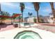Backyard features an inground pool, hot tub, lounge seating, tall palm trees, and a brick patio at 3793 Casa Colorado Ave, Las Vegas, NV 89121