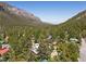 Aerial view of a cozy cabin nestled among lush trees, set against the backdrop of majestic mountains at 3971 Arlberg Way, Mount Charleston, NV 89124