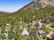 Aerial view of a cozy cabin nestled in a lush forest, with mountains creating a scenic, serene setting at 3971 Arlberg Way, Mount Charleston, NV 89124