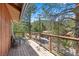 A spacious balcony with seating and a scenic view of the surrounding lush greenery at 3971 Arlberg Way, Mount Charleston, NV 89124