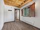 Bedroom with natural light, wood-look flooring, wood-clad ceiling and custom wood shutters at 3971 Arlberg Way, Mount Charleston, NV 89124
