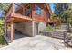 Exterior showcasing a two-story home, stairs, patio, wood pile and concrete driveway at 3971 Arlberg Way, Mount Charleston, NV 89124