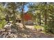 A rustic cabin with a two-story design and surrounded by trees, offering a tranquil retreat in nature at 3971 Arlberg Way, Mount Charleston, NV 89124