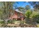 Charming cabin with a spacious deck, surrounded by lush trees, offering a serene outdoor living space at 3971 Arlberg Way, Mount Charleston, NV 89124