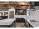 Modern kitchen featuring an island with granite countertops, dark cabinets, and stainless steel appliances at 3971 Arlberg Way, Mount Charleston, NV 89124