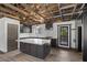 Modern kitchen with an island with granite countertops, dark cabinets, and stainless steel appliances at 3971 Arlberg Way, Mount Charleston, NV 89124