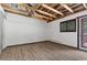 The room features exposed beam ceiling and offers a view of the deck through the open glass door at 3971 Arlberg Way, Mount Charleston, NV 89124