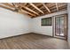 Bright room featuring exposed beam ceiling and open access to the deck through the glass door at 3971 Arlberg Way, Mount Charleston, NV 89124