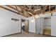 Room featuring exposed beam ceiling, neutral walls, and open access to other rooms, creating a blank canvas at 3971 Arlberg Way, Mount Charleston, NV 89124