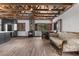 Open concept living room featuring exposed beam ceiling and wood-burning stove with a dining area at 3971 Arlberg Way, Mount Charleston, NV 89124