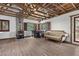 A cozy living room area with a wood burning stove and exposed beam ceiling, adjacent to the dining area at 3971 Arlberg Way, Mount Charleston, NV 89124