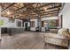 Open floor plan featuring exposed beam ceiling, dining area, wood burning stove, and a kitchen area at 3971 Arlberg Way, Mount Charleston, NV 89124