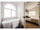 Bathroom features freestanding tub, black marble flooring, and modern faucet, leading into bedroom at 4065 Genoa Dr, Las Vegas, NV 89141