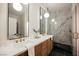 Modern bathroom with dual vanities, stylish mirrors, and a luxurious walk-in shower at 4065 Genoa Dr, Las Vegas, NV 89141