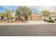 Charming single-story home showcasing a well-maintained yard, mature trees, and a spacious three-car garage at 4065 Genoa Dr, Las Vegas, NV 89141