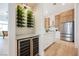 Modern kitchen features stainless steel appliances, custom cabinets, wine rack and beverage refrigerator at 4065 Genoa Dr, Las Vegas, NV 89141