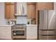 Bright kitchen boasts stainless steel appliances and white countertops with wood-tone cabinets at 4065 Genoa Dr, Las Vegas, NV 89141