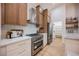 Modern kitchen features stainless steel appliances, white counters, and natural wood cabinetry at 4065 Genoa Dr, Las Vegas, NV 89141