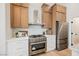 This kitchen features modern appliances, wood cabinets, and stone countertops with a subway tile backsplash at 4065 Genoa Dr, Las Vegas, NV 89141