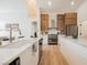 This kitchen features stone countertops, modern appliances, wood cabinets, and an island with bar stool seating at 4065 Genoa Dr, Las Vegas, NV 89141