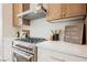 This kitchen features modern appliances, wood cabinets, and stone countertops with a subway tile backsplash at 4065 Genoa Dr, Las Vegas, NV 89141