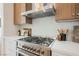 This kitchen features modern appliances, wood cabinets, and stone countertops with a subway tile backsplash at 4065 Genoa Dr, Las Vegas, NV 89141