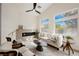 Bright living room featuring high ceilings, modern fireplace, and large windows with a view at 4065 Genoa Dr, Las Vegas, NV 89141