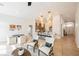 This living room features an open floor plan, modern lighting, lots of natural light, and seamless access to the kitchen at 4065 Genoa Dr, Las Vegas, NV 89141