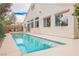Backyard oasis featuring a sparkling pool, spacious patio area, and a serene outdoor setting at 4065 Genoa Dr, Las Vegas, NV 89141