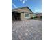 The backyard features a large brick paved area, shrubs, and a landscaped garden at 4108 Fairywren Dr, North Las Vegas, NV 89031