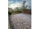 Wide backyard with beautiful brick pavers, lawn section, and decorative plants at 4108 Fairywren Dr, North Las Vegas, NV 89031