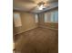 Bedroom with neutral carpet, white-shuttered windows and a ceiling fan at 4108 Fairywren Dr, North Las Vegas, NV 89031
