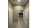 Hallway view with tile flooring, white walls, and a storage room in the background with paint supplies at 4108 Fairywren Dr, North Las Vegas, NV 89031